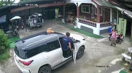 SUV drives out of garage with pet cat still resting on its roof