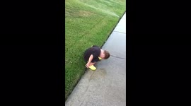Boy Sits On Sprinklers