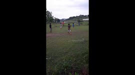 Amazing scene of playing football in a beautiful village school field . School student play football on field in India