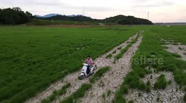 Motorists drive over dried-up lake as heatwave scorches southern China