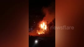 Firefighters burn inflammable material to stop mountain fire in southern China