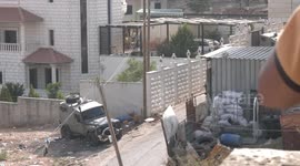Smoke billows from a building during clashes between Israeli forces and Palestinians in the town of Rujayb