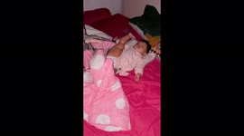 The baby sleeps in a very unusual position with her leg up!