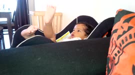 6 month old baby fascinated with his foot and toes. Singing as he looks longingly at it.