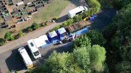 Police forensics officers sift through earth flowing discovery of human remains in a skip at Tipton Cemetery, England