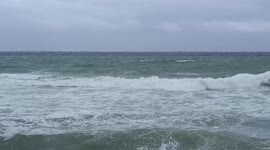 Beautiful tourist beach turns gloomy as storm clouds blanket skies due to Typhoon Hinnamnor