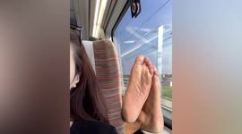 Sole train! Man rests bare feet next to passenger's face on train in China