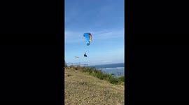 Beautiful paragliding moment over the Indian Ocean in Bali Island.
