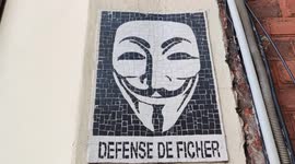 Street art mosaic of the Anonymous reading 