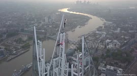 Nail-biting drone footage shows daredevil teetering on tip of The Shard, UK's tallest building