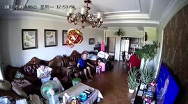 Elderly Chinese man calmly lies on sofa as earthquake rocks lampshade