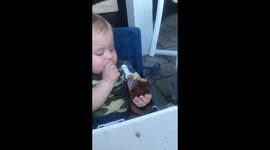 9 month old Baby, Jason, enjoys eating his first hamburger on 4th of July weekend.