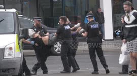 Spit and Bite mask incident in public as police apply the controversial device to an individual apprehended and taken away in police vehicle Newquay Cornwall UK
