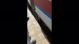 Lucky man narrowed himself between railway line and platform as 17 coaches of train pass over him