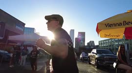 Slo mo of a man dancing at a house music event with the Los Angeles skyline set behind