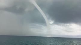 Panicked fishermen rush to escape waterspout that formed near their boat