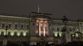 Crowds gather in the rain at the gates of Buckingham Palace to mourn the passing the The Queen