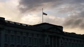 The Union Jack fly's at half mast during sunset if the Queen's very last day. People remain outside the palace climbing on the statues