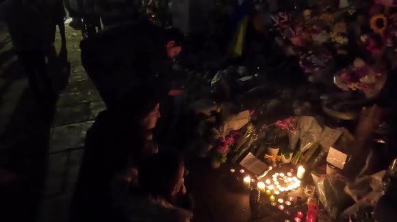 Candles arranged in a heart shape outside Buckingham Palace at midnight