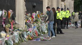 Mourners lay flowers outside Buckingham Palace in London following HM Queen's death