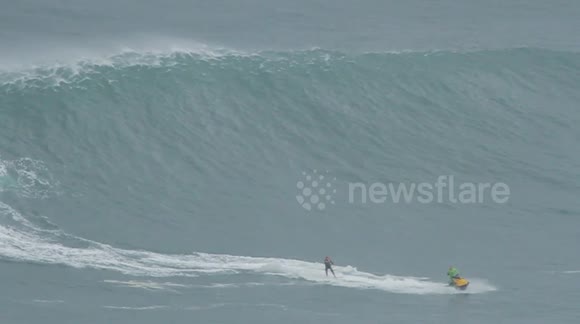British surfer Andrew Cotton tackles a huge wave in Nazare, Portugal