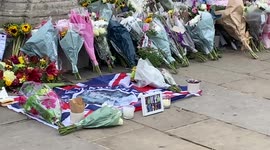 Candles, flags and flowers at Buckingham Palace gates after Queen’s death