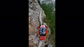 view of a cyclist's helmet as he descends a large and adventurous cliff