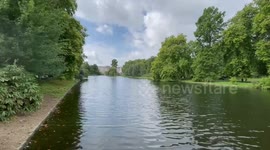 People leave love notes for the Queen in front of Buckingham Palace as gun salute held nearby park