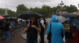 Despite the heavy rain people pay their respects to the Queen outside Buckingham Palace