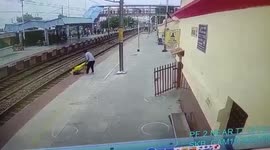 Woman crossing railway tracks gets pulled out danger by official in northern India