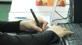 A Palestinian Samar Nassar, draws graphic cartoon characters wearing traditional Palestinian dress