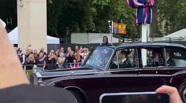 King Charles waves to crowd as he arrives at Buckingham Palace ahead of procession