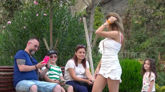 Homewrecker? Woman hilariously asks men to take sultry photos of her in front of their companions