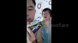 Malaysian toddler cries desperately as father eats chocolate in front of her