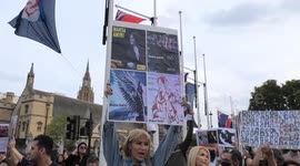 Iranian man burns image of Iran's Supreme leader at Parliament Square during protest against Iranian government