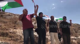 Palestinians protesters take part during a protest against the establishment of Israeli outposts