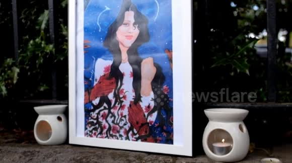 Makeshift shrine to Mahsa Amini at protest outside the Iranian Embassy in London