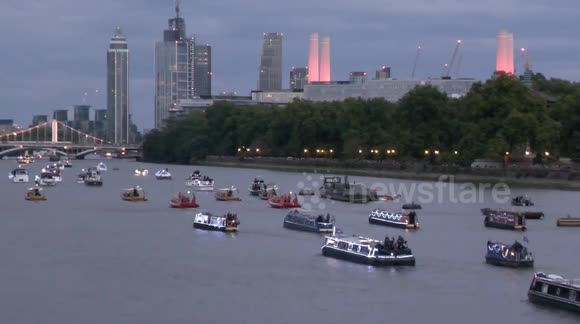 Crowds line the Thames to watch flotilla of 150 boats sail down the river as a tribute to the Queen
