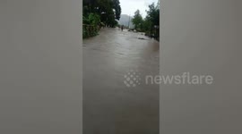 Flood cascades over newly built bridge as Typhoon Noru hammers the Philippines