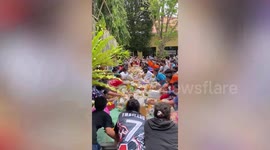 Devotees scramble for food at religious festival in Thailand