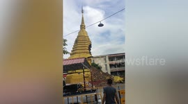 Buddhist pagoda COLLAPSES after being battered by rain during Typhoon Noru in Thailand