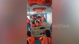 Terrified tourists cling to seats as enormous tidal wave pounds boat in the Philippines
