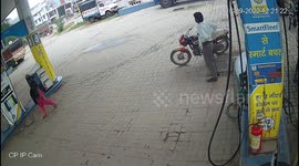 Motorcycle suddenly catches fire at petrol pump , quick reaction of salesman averted big mishap