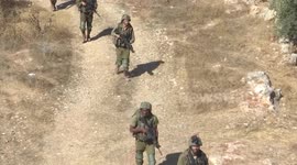 Israeli forces conduct a search in Salem town following reports of a shooting attack on a bus