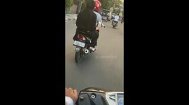 The girl does not know what to do with melting ice cream while riding a bike!