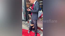 Local Chinese tradition sees woman hold onto groom's leg until she's given money