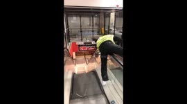 Man crazily slides down escalator's railing to kill his boredom