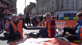 Just Stop Oil activists lock and glue themselves on roads around Trafalgar Square in London
