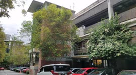 Special building grown with green bushes but here not deserted