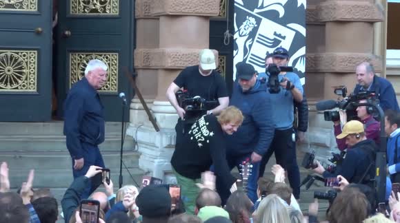 Ed Sheeran gives away his guitar to 10-year-old fan during impromptu concert in Ipswich, England